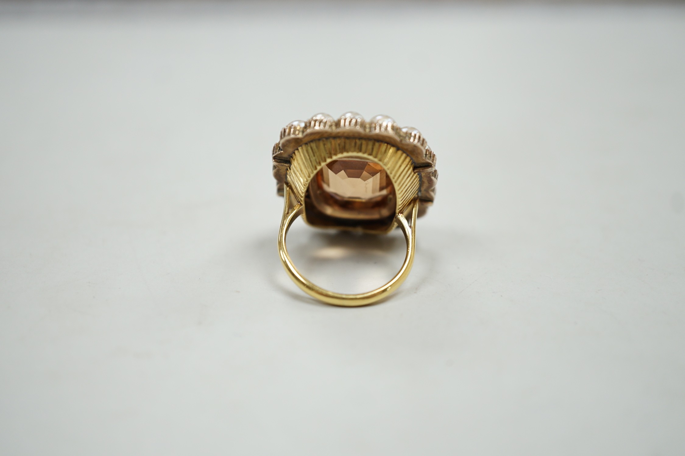 A mid 20th century gold, orange topaz and split pearl set cluster ring (adapted from an earlier brooch), size M/N, gross weight 15.7 grams.